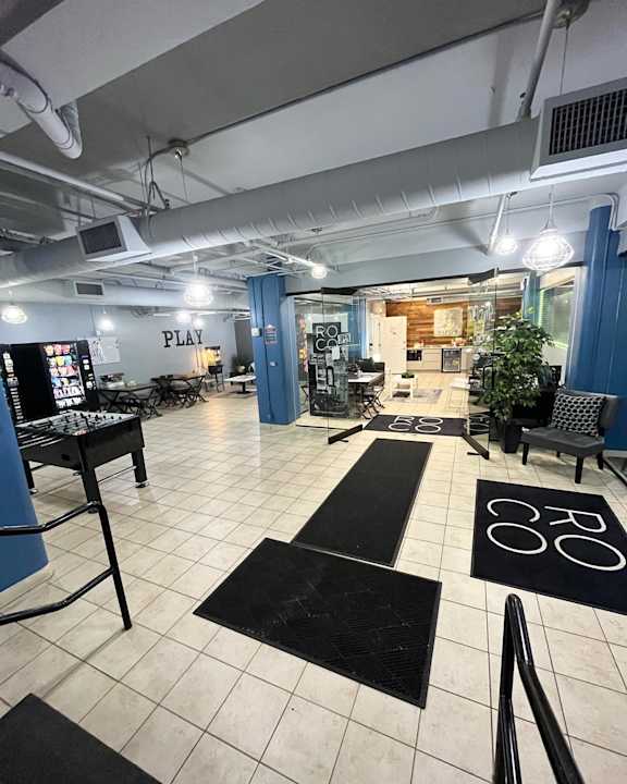a large room with lots of seating and a foosball table