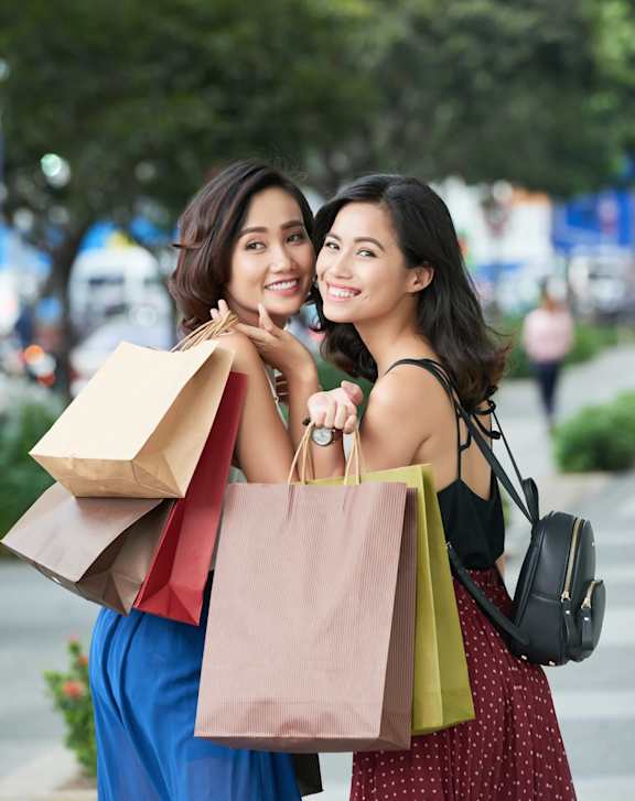 Two women carrying shopping bags.