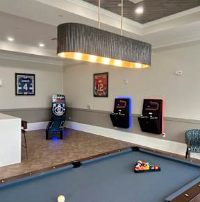 a game room with a pool table and a couch