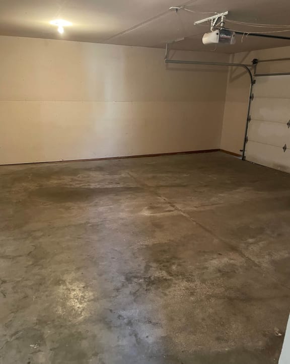 a garage with white walls and a concrete floor