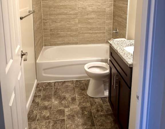 a small bathroom with a toilet and a bath tub