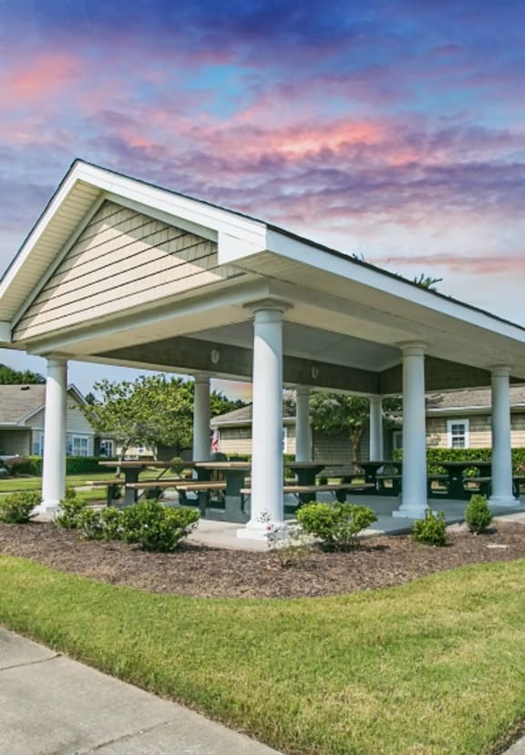 a pavilion with a picnic table in front of it