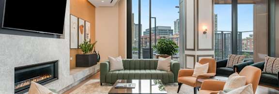 A modern living room with a fireplace and a view of the city.