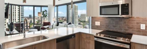 A modern kitchen with a view of the city.