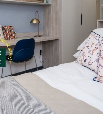 a bedroom with a bed and a desk with a chair