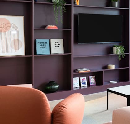 a living room with couches and a coffee table and a television