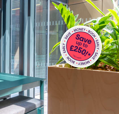 A table with a plant on it and a sign that says Save money.