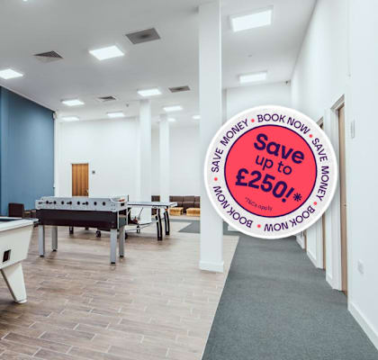 A billiard table is in a room with a sign offering a discount.
