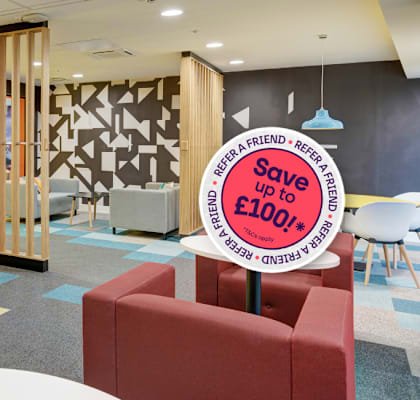 A sign in a room with tables and chairs advertises a discount.