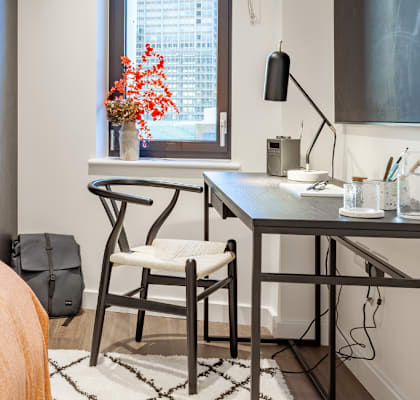 a bedroom with a bed and a desk with a chair