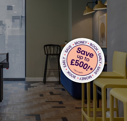 A room with a table tennis table and chairs with a sign that says "Save up to £500".