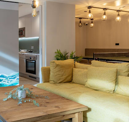 a living room with a large painting of a wave on the wall