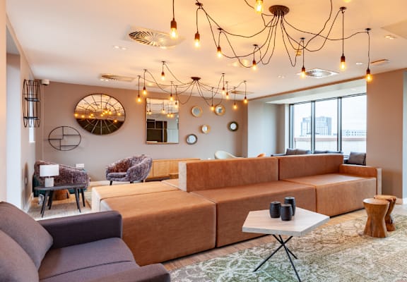 a living room filled with furniture and a large window