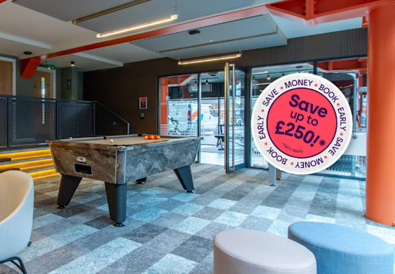 A room with a pool table and a sign that says Save Money.