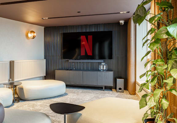 a living room with couches and chairs and a television