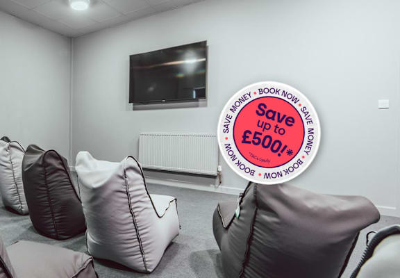 A room with chairs and a sign that says Save up to £500.
