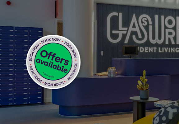 A reception area for Glassworks student living with a sign offering bookings now.