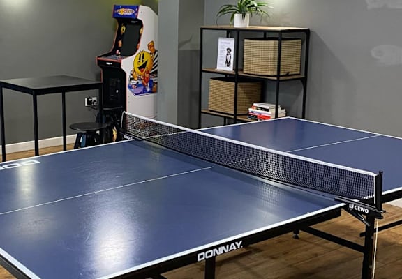 a blue ping pong table in a room