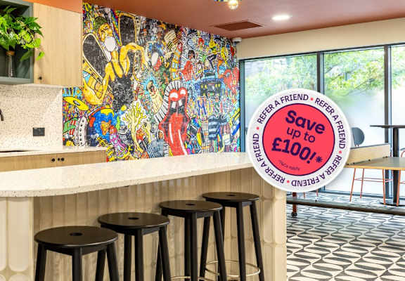 A kitchen with a white counter and a sign that says "Save £100".