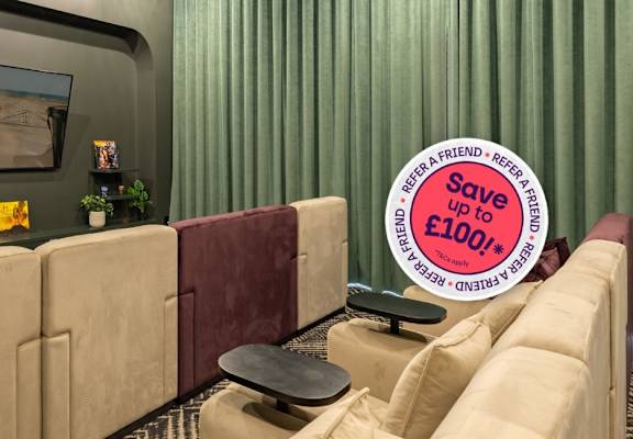 A living room with a couch and a sign that says "Save £100".