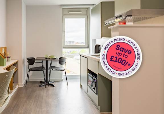 A room with a desk and a chair with a sign that says "Save up to £100".