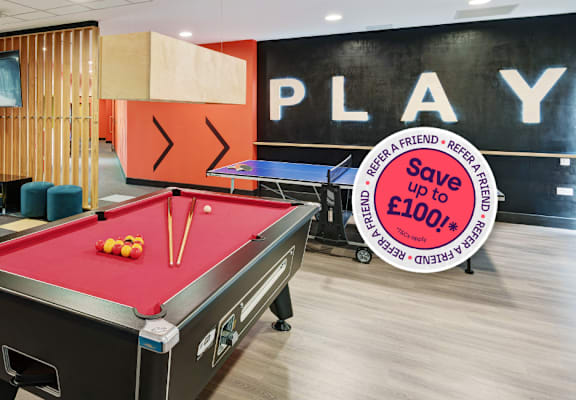 A pool table with a sign that says "Save £100" in the background.