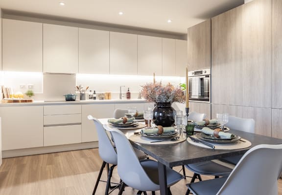 a kitchen and dining room with a table and chairs