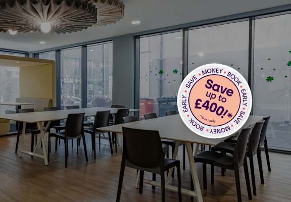 A room with a table and chairs and a sign that says "Save money, buy big".