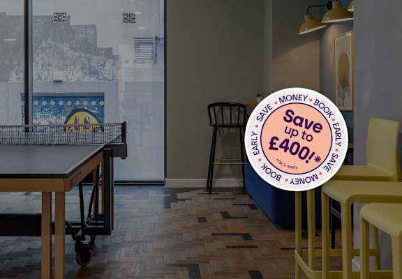 A room with a table tennis table and chairs with a sign that says "Save up to £400!"