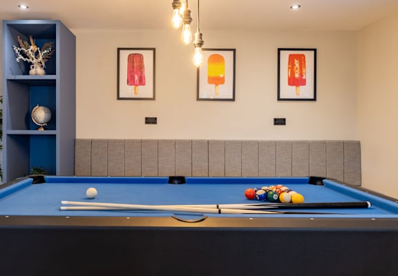 a pool table in a room with a tv on the wall