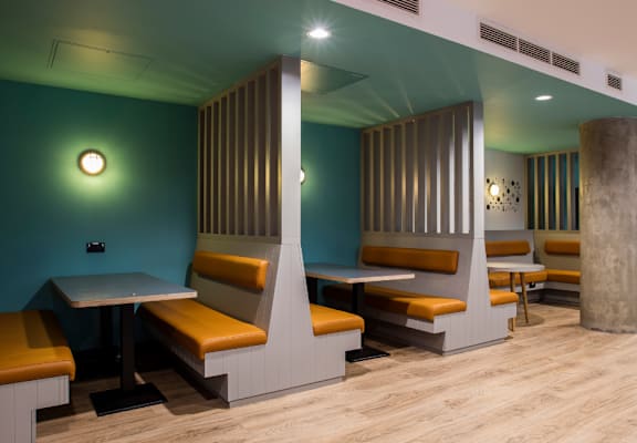 a dining room with tables and chairs and a pillar