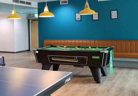 a games room with a ping pong table