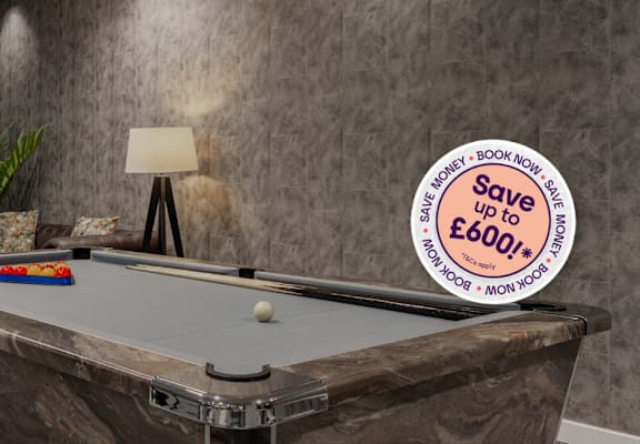 A pool table with a sign that says "Save up to £600+".