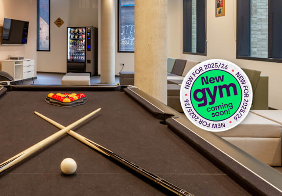 A pool table with a ball and cues in the middle of it.