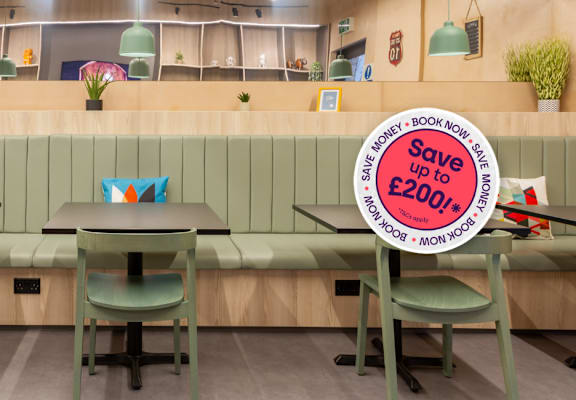 A restaurant interior with a sign offering a discount on bookings.