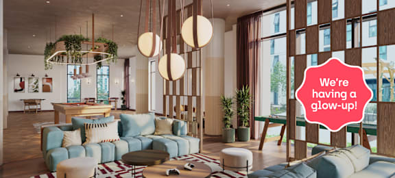 A modern living room with a large sofa and a hanging plant.