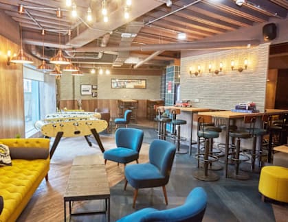 A modern cafe with yellow and blue chairs.