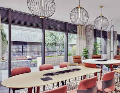 A modern dining room with a long table and chairs.