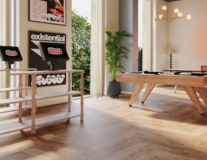 A room with a pool table and a sign that says "This is a conversation area please keep talking.".