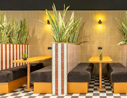A restaurant with striped booths and a checkered floor.