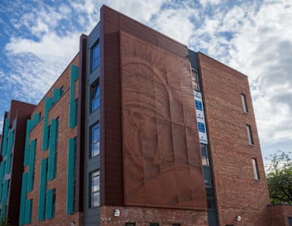 A modern building with a large mural on the side.