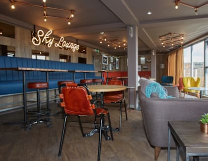 A cafe with a blue booth and a sign that says "Sly Lounge".