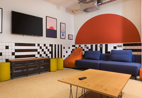 A living room with a blue couch and a television.