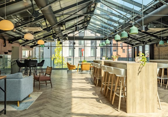 A modern interior with a glass ceiling and wooden furniture.