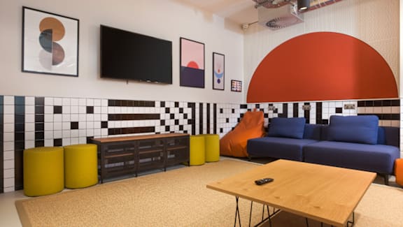 A living room with a blue couch and a television.