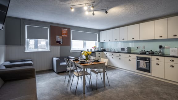 A kitchen with a table and chairs in the middle of the room.