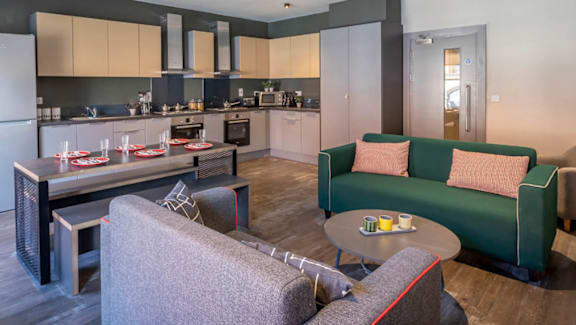 A modern kitchen with a dining table and chairs.
