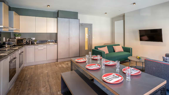 A modern kitchen with a dining table set for six.