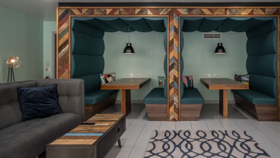 A room with a couch, a table, and a bench.