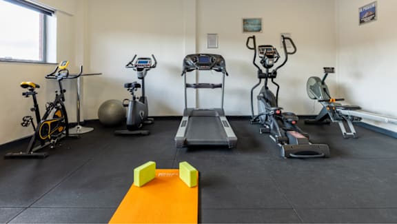 A gym with a variety of cardio equipment.